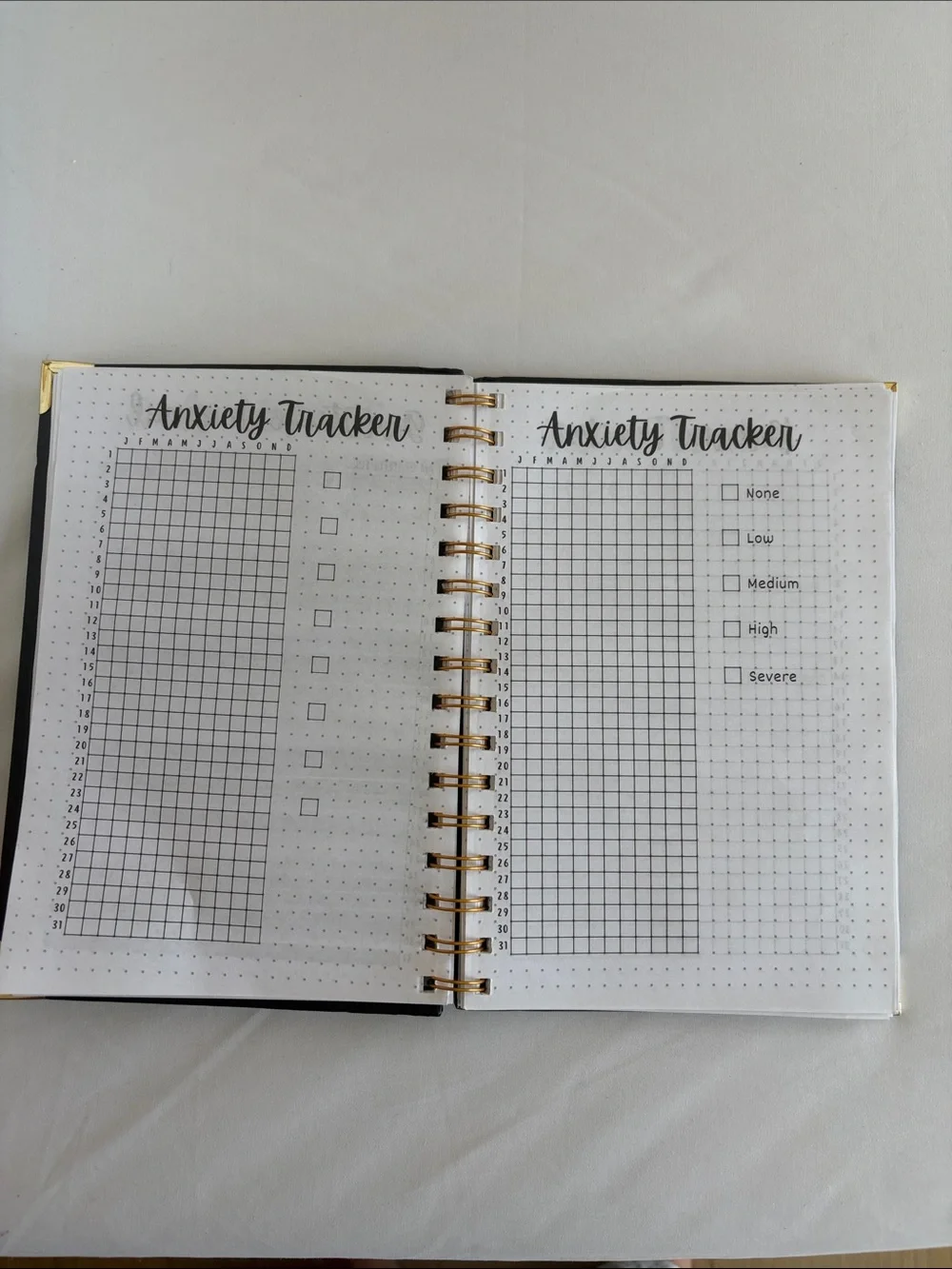 Bullet Journal Game Spiral Notebook in Black with Colored Pencils